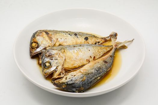 Fried mackerel on white plate. Deep fried fish