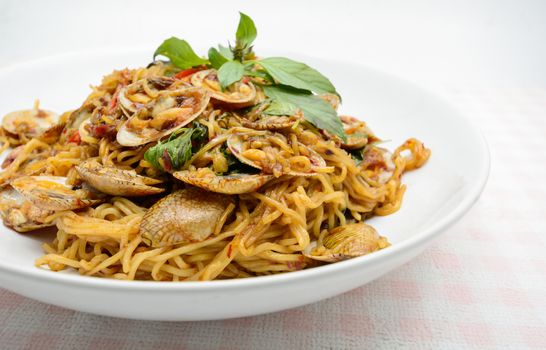 Stir fried noodles with clams and herbs, hot and spicy dish