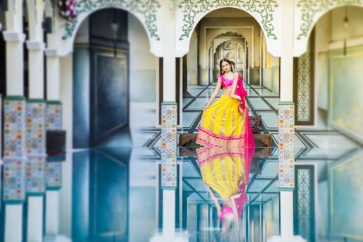 Pink and Yellow Indian Costume Beautiful Girl, face partially covered with saree. Portrait of Traditional woman in sari dress.
