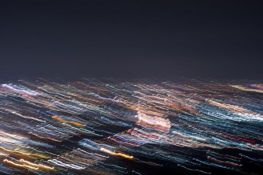 Abstract long exposure, experimental surreal photo, city and vehicle lights at night
