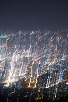 Abstract long exposure, experimental surreal photo, city and vehicle lights at night
