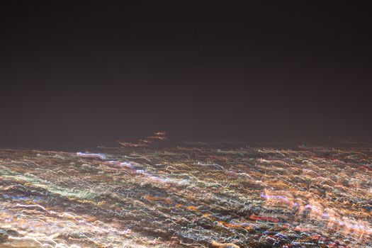 Abstract long exposure, experimental surreal photo, city and vehicle lights at night
