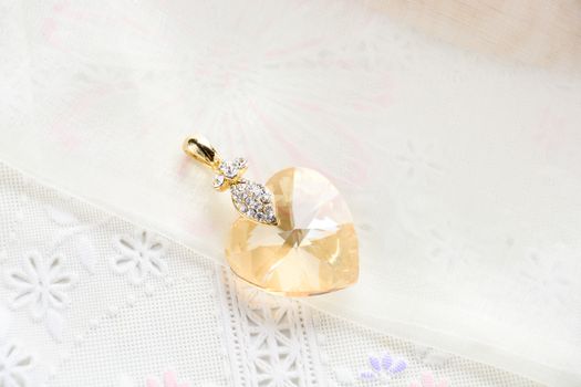 Crystal necklace on white fabric background
