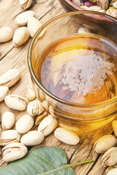 Beer glasses on old wooden table.Beer and salted pistachios