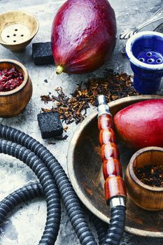 Smoking hookah.Details of shisha.Shisha with mango aroma of tobacco.