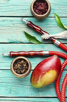 Smoking hookah.Details of shisha.Shisha with mango aroma of tobacco.