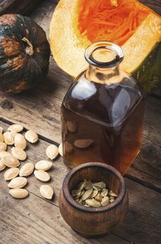 Pumpkin and pumpkin seed oil on wooden table