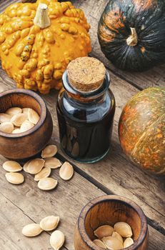 Pumpkin and pumpkin seed oil on wooden table