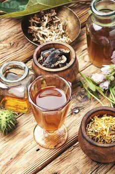 Mortar and bowl of raw and dried healing herbs.Alternative or herbal medicine