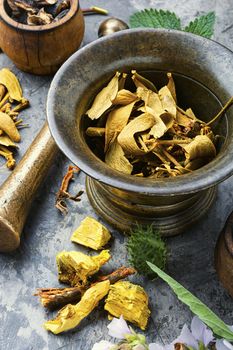 Healing herbs with mortar and bottle of elixir.Alternative or herbal medicine