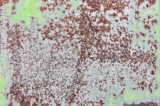 background texture pattern of old rusty iron wall with green paint close up
