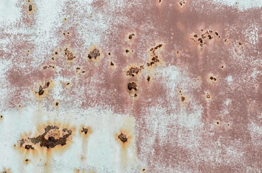 background texture pattern of old rusty iron wall with orange paint close up