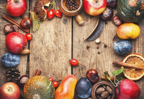 Fruits and pumpkins,nut in autumn still life on wooden table.Fall still life.Autumn background