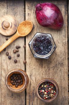 Homemade red onion jam.Onion confiture on old wooden table