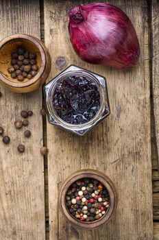 Homemade red onion jam.Onion confiture on old wooden table