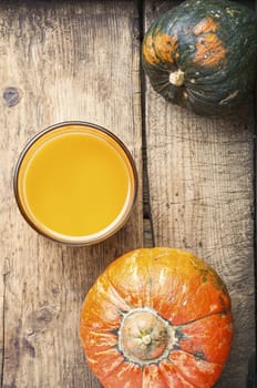 Fresh pumpkin juice.Autumn pumpkin drink.Juice on wooden table