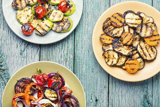 Grilled vegetables on wooden table.Large portion of grilled vegetables