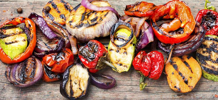 Grilled vegetables on wooden table.Large portion of grilled vegetables