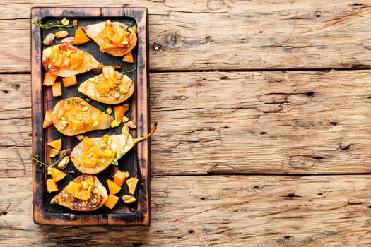 Stuffed pear pumpkin and pistachio.Baked pear.Autumn food.