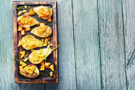 Stuffed pear pumpkin and pistachio.Baked pear.Autumn food.