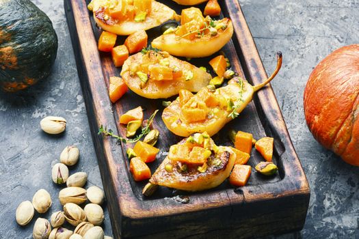 Stuffed pear pumpkin and pistachio.Autumn food.Baked pear dessert