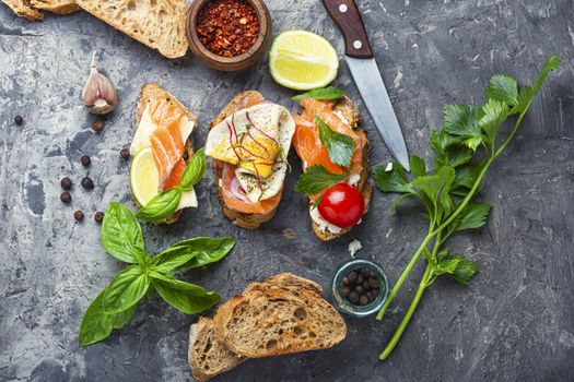 Traditional italian bruschetta.Open sandwich with salmon and vegetables