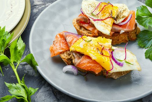 Traditional italian bruschetta.Open sandwich with salmon and vegetables