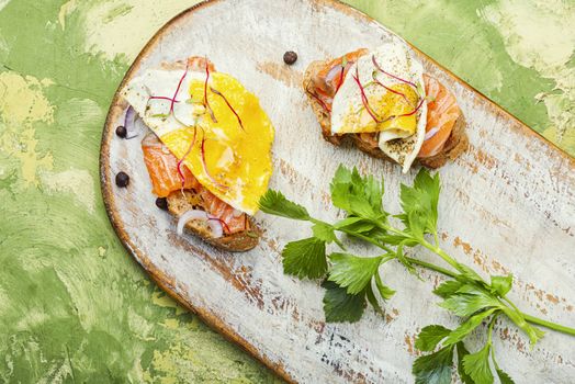 Traditional italian bruschetta.Open sandwich with salmon and vegetables