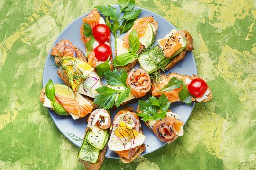 Traditional italian bruschetta.Open sandwich with salmon and vegetables