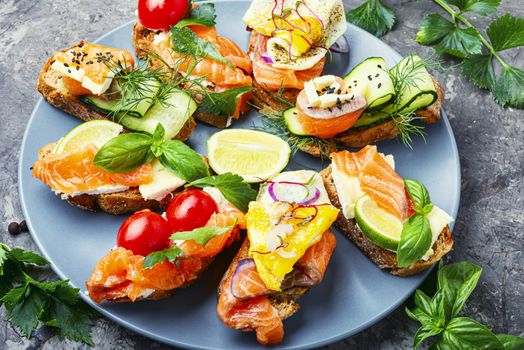 Traditional italian bruschetta.Open sandwich with salmon and vegetables