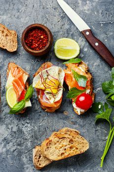 Open sandwich with salmon and vegetables.Delicious toasts with salmon