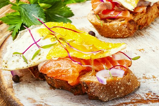 Traditional italian bruschetta.Open sandwich with salmon and vegetables