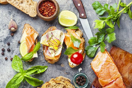 Open sandwich with salmon and vegetables.Small sandwiches.Toasts with salted salmon