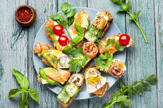 Traditional italian bruschetta.Open sandwich with salmon and vegetables