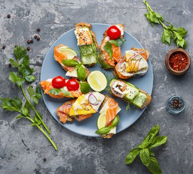 Traditional italian bruschetta.Open sandwich with salmon and vegetables