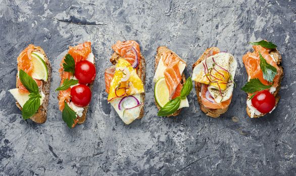 Traditional italian bruschetta.Open sandwich with salmon and vegetables