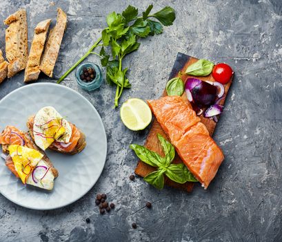 Traditional italian bruschetta or canape.Open sandwich with salmon and ingredients