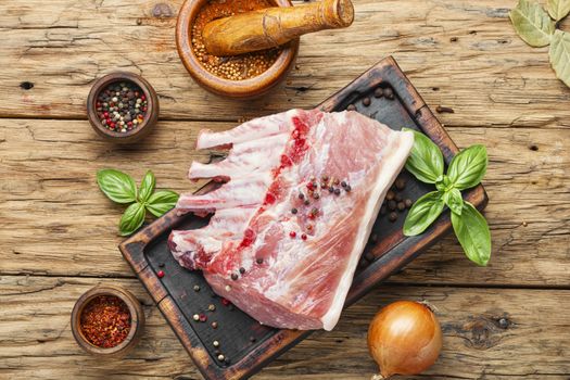 Ribs and pork chops on old wooden table