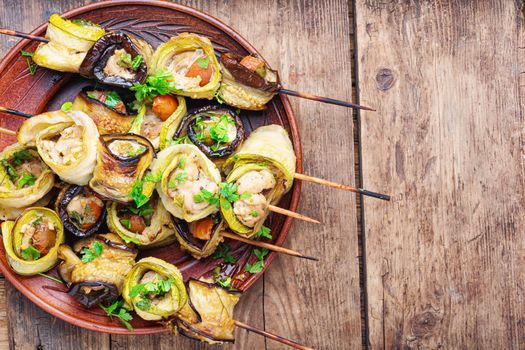 Eggplant and zucchini stuffed with chicken meat.Skewers of grilled meat and vegetables