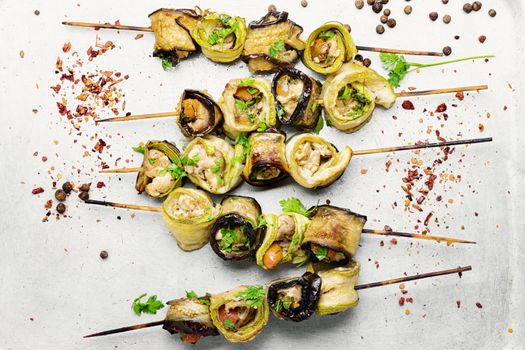 Eggplant and zucchini stuffed with meat on skewers