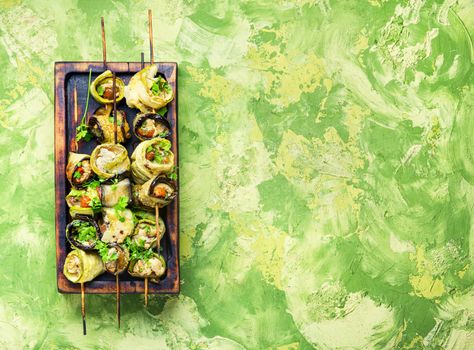 Eggplant and zucchini stuffed with meat on skewers.Flat lay with copy space