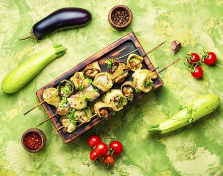 Eggplant and zucchini stuffed with meat on skewers.Flat lay with copy space