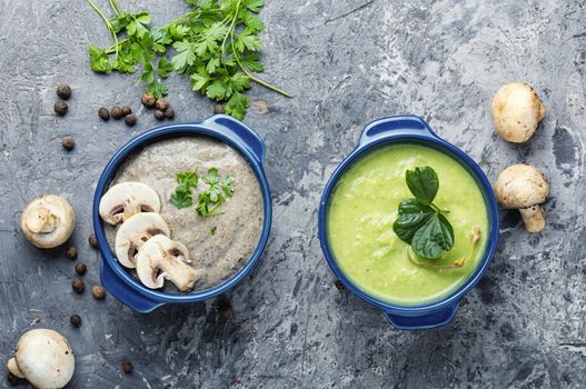 Delicious soup puree with champignons and fresh mushrooms on rustic table