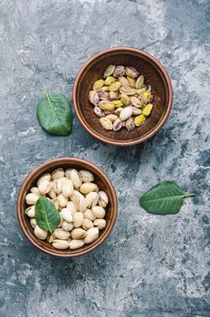 Pistachio with leaf.Dish full of pistachios.Nut.Pistachio in nutshell