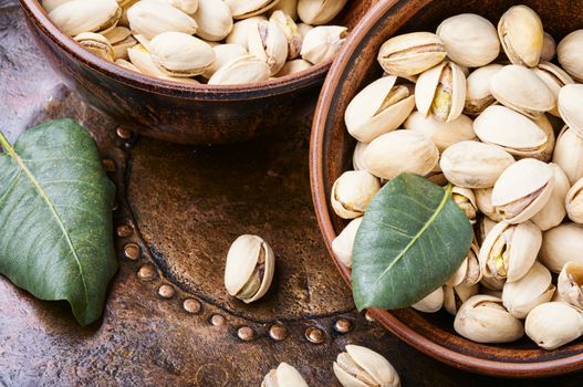 Pistachio with leaf.Dish full of pistachios.Nut.Pistachio in nutshell