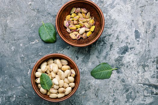 Pistachio with leaf.Dish full of pistachios.Nut.Pistachio in nutshell