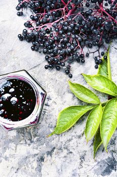 Homemade preserves of fresh elderberry in glass jar