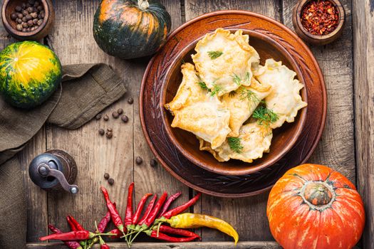 Traditional autumnal pumpkin dumplings.Fried pumpkin vareniki.Autumn food