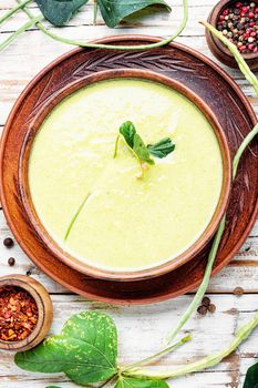 Green asparagus bean soup.Vegetable soup.Soup with asparagus on wooden background