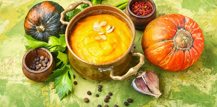 Vegetarian autumn pumpkin cream soup.Pumpkin soup and organic pumpkins
